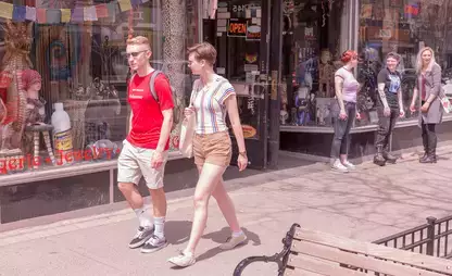 Students walk and window shop along Main Street in downtown Oneonta