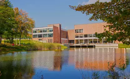 A fall season view of Hunt Union reflected across the pond