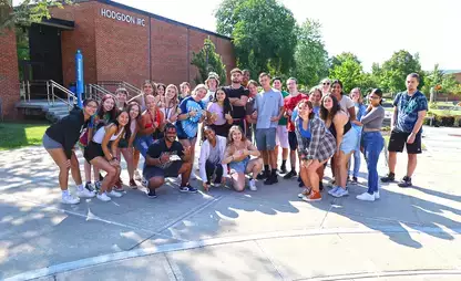 A group of students pose during fall orientation on campus