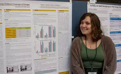 Student presenting their research at a research showcase on campus