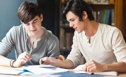 Individuals review material during a tutoring leadership course
