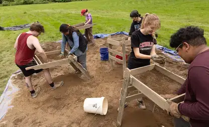 Students sift through material collected at the Archaeology Field School