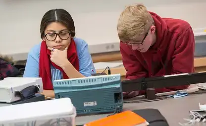 Physics students perform experiments in the lab