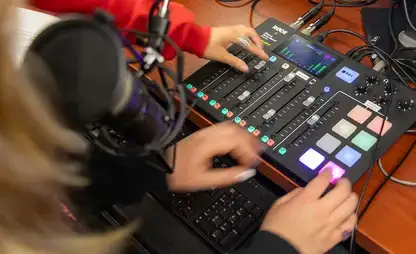 Students operate editing equipment in a media suite