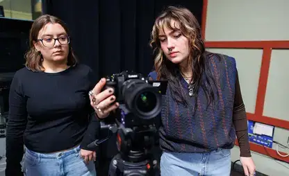 Students adjust rented camera settings