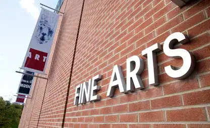 Signage on the red brick Fine Arts Building.
