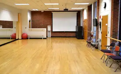 Acting studio with ballet barres and mirrors.