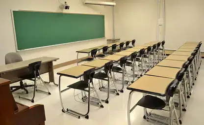 Small shared classroom with chalkboard.