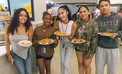 Summer Academy students show off their full plates in Wilsbach Dining Hall.
