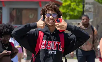 Smiling student with "two thumbs up"