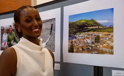 Lidia Boucher stands next to her photo during the Portugal photography exhibit.