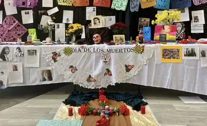 A table and decorations on display celebrating Dia de los Muertos.