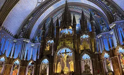 Interior view of a cathedral vault in Montreal, with purple and gold lighting.