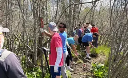 Students work outside on trail maintenance.