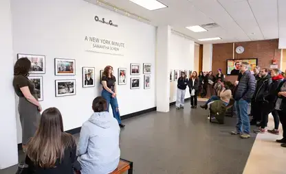 Artist Samantha Schein '24 speaks to an audience during the opening reception of her solo exhibition, 'A New York Minute.' 