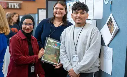 SRCA students pose with one of their projects.