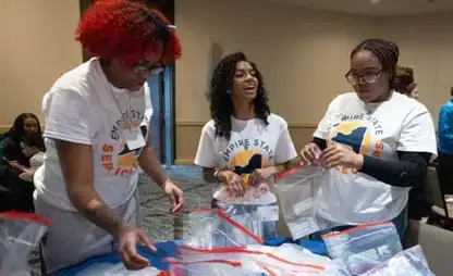 Three women work together as part of the SUNY Service Corps.