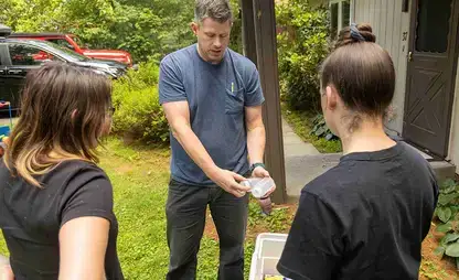 Dr. McGuffin describes how to do well water testing to a group of students.
