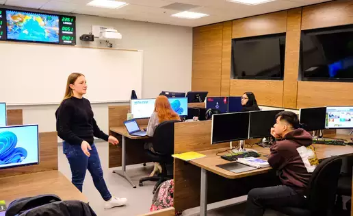 Accounting students discuss the subject in one of the high-tech business school rooms.