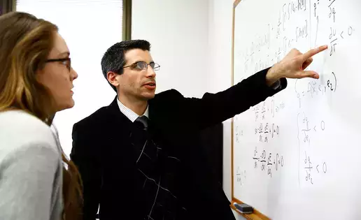 Philip Sirianni, assistant professor of economics, meets with a student to discuss their research project