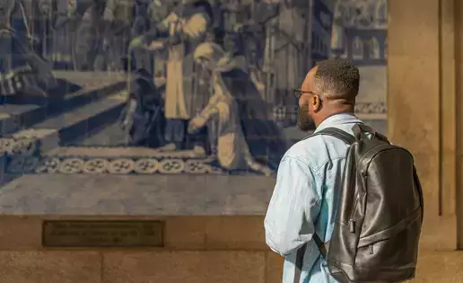 African American individual taking in some artwork
