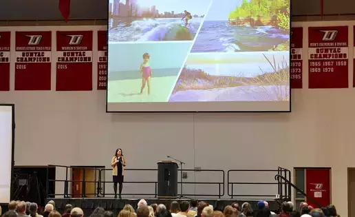 An audience listens to a lecture about health and society
