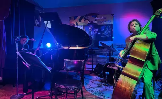 A pianist and upright bass player perform live jazz