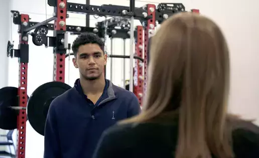 An intern discusses sports management with a physical trainer