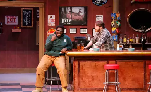 Students perform on stage in a production of live theatre