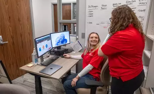 Volunteers discuss income tax assistance