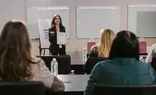 A presenter speaks to a group of attendees