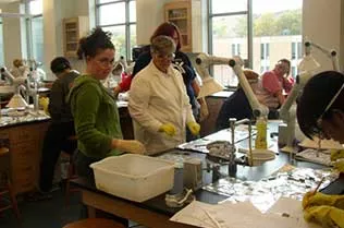 Students testing different fabrics in a lab.