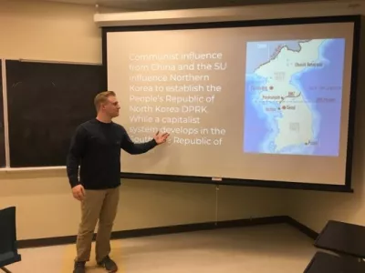 Student giving a presentation on South Korea.