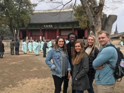Students posing in front of a shrine in South Korea