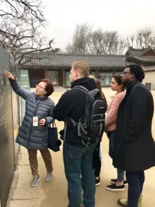 Students looking at a memorial wall in South Korea