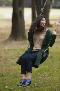 Girl swinging on a swing in a forest.