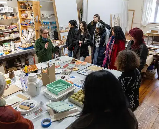 Adjunct instructor Carrie Smith speaks to students in her 3D design and painting studio.