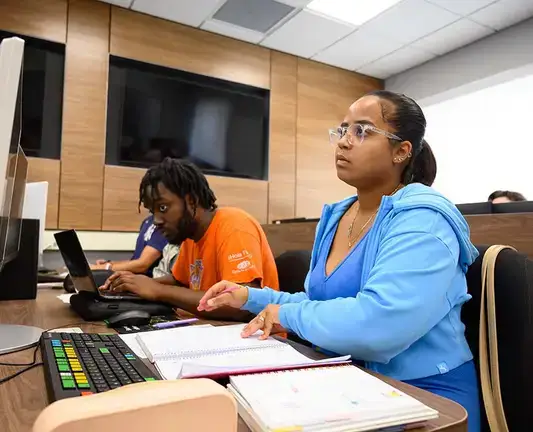 Students work at Bloomberg terminals during a business class.