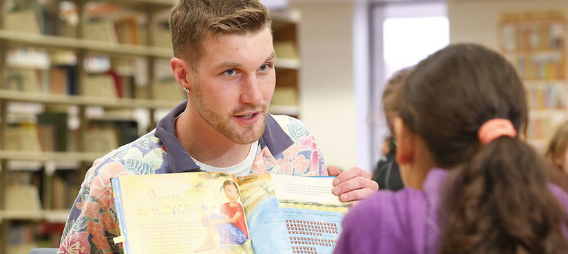 SUNY Oneonta student reading to a child